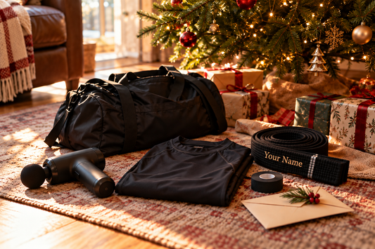 BJJ gifts under a Christmas tree on Christmas morning: massage gun, duffel bag, rash guard, black belt, tape and a gift envelope