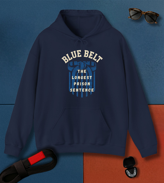 Navy blue BJJ hoodie with 'Blue Belt The Longest Prison Sentence' text on a blue and orange gradient background.